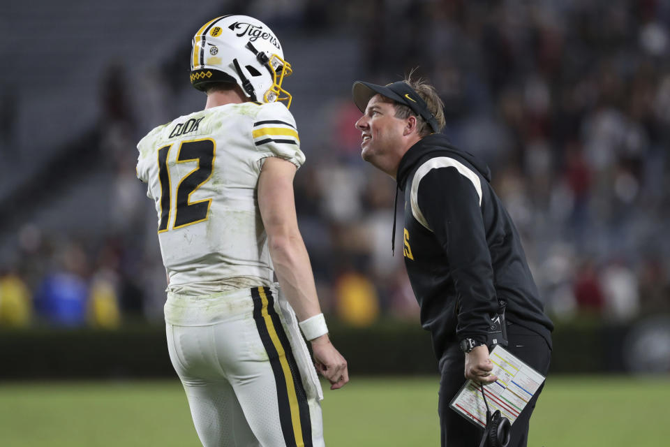 Missouri head coach Eliah Drinkwitz, right, talks to quarterback Brady Cook (12) during the second half of an NCAA college football game against South Carolina, Saturday, Oct. 29, 2022, in Columbia, S.C. (AP Photo/Artie Walker Jr.)