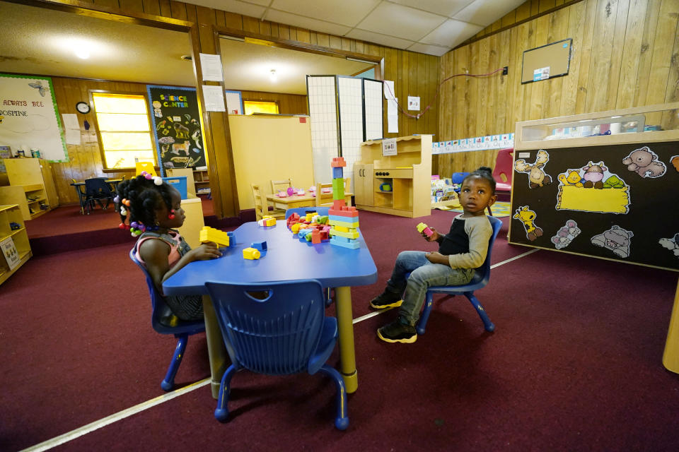 Children build a block structure in the main classroom of the School of Champions Development & Learning Academy in Itta Bena, Miss., Thursday, Oct. 22, 2020. The owner Patricia Young has spearheaded a petition signed by 300 residents asking the state auditor to launch an investigation into why they are paying what they believe is a high price for electricity from the city-run and owned utility, and yet the city has a long standing debt with the wholesale electrical provider, and is now facing complete disconnection on Dec. 1. (AP Photo/Rogelio V. Solis)