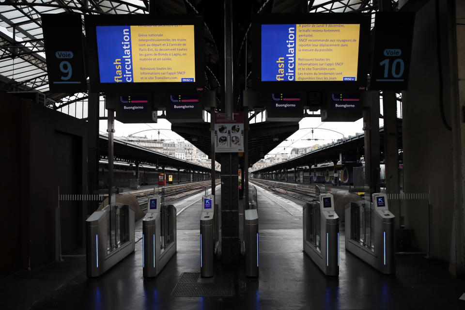 Informations boards display strike informations as platforms are empty at Gare de L'Est train station in Paris, Saturday, Dec. 7, 2019. French strikes are disrupting weekend travel around the country, as truckers blocked highways and most trains remained at a standstill because of worker anger at President Emmanuel Macron's policies as a mass movement against the government's plan to redesign the national retirement system entered a third day. (AP Photo/Francois Mori)