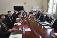 Lebanese Foreign Minister Nassif Hitti, second right, receives his French counterpart Jean-Yves Le Drian, second left, at the Lebanese Foreign Ministry in Beirut, Lebanon, Thursday, July. 23, 2020. Le Drian met with Lebanon's president Thursday at the start of his two-day visit to the Mediterranean country that is witnessing the worst economic crisis of its modern history. (AP Photo/Bilal Hussein)