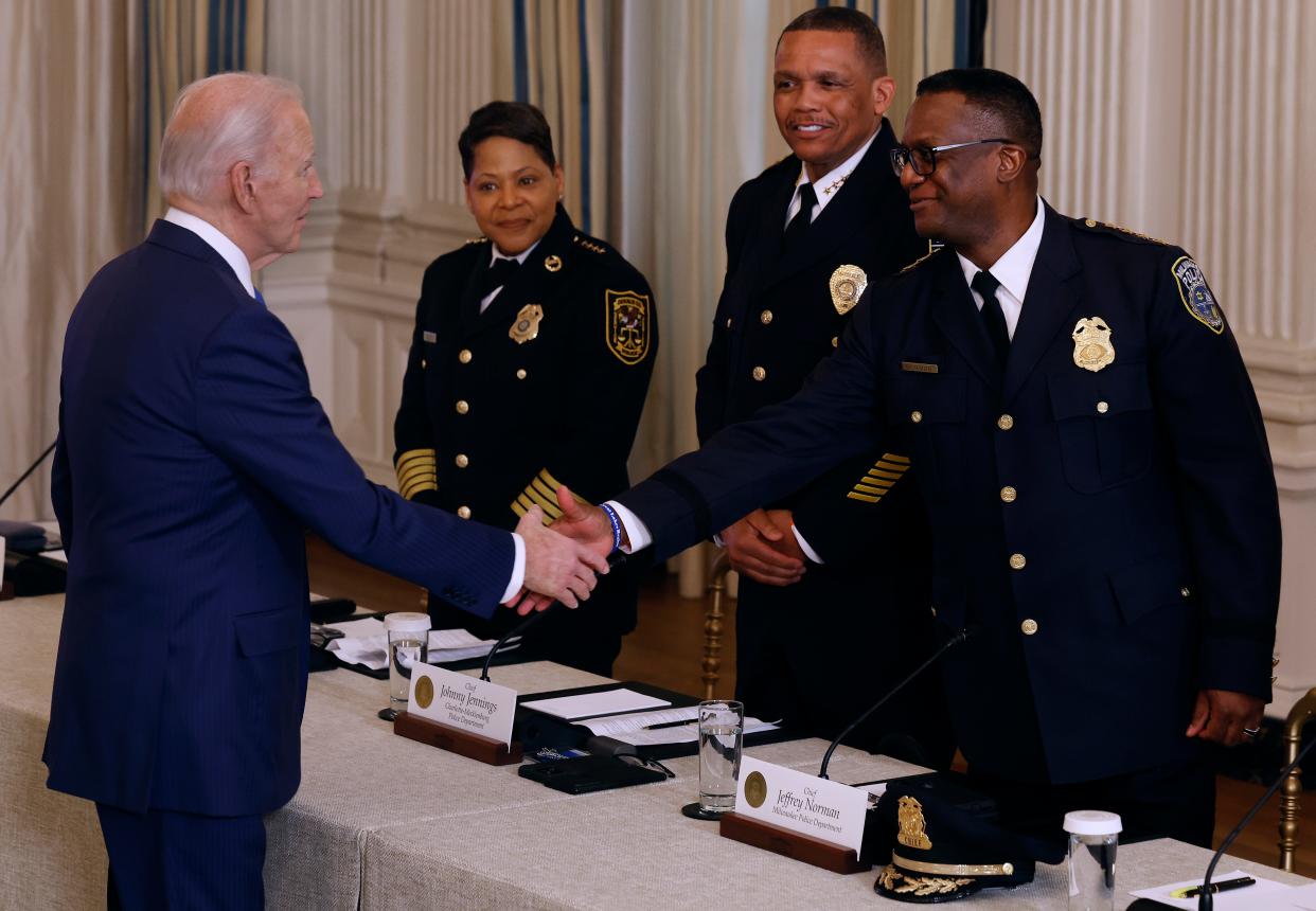 President Joe Biden greets Milwaukee Police Chief Jeffrey Norman before a meeting with Norman and other police chiefs from across the country and members of his administration in the State Dining Room at the White House on Feb. 28, 2024, in Washington. Biden touted achievements in reducing crime.