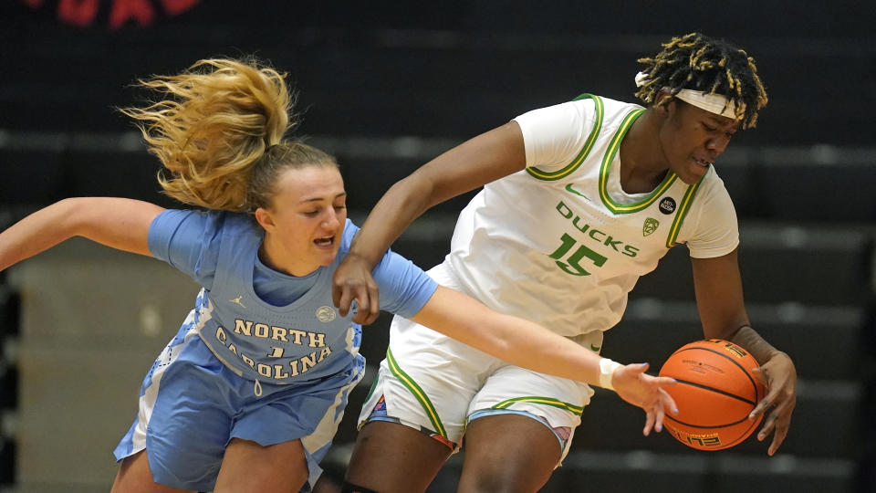 North Carolina guard Alyssa Ustby, left, and Oregon center Phillipina Kyei (15) battle for the ball during the first half of an NCAA college basketball game in the Phil Knight Invitational tournament Thursday, Nov. 24, 2022, in Portland, Ore. (AP Photo/Rick Bowmer)