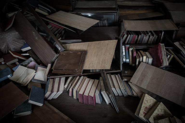 Books lie on the floor of the Kaiser Library in Kathmandu on May 7, 2015