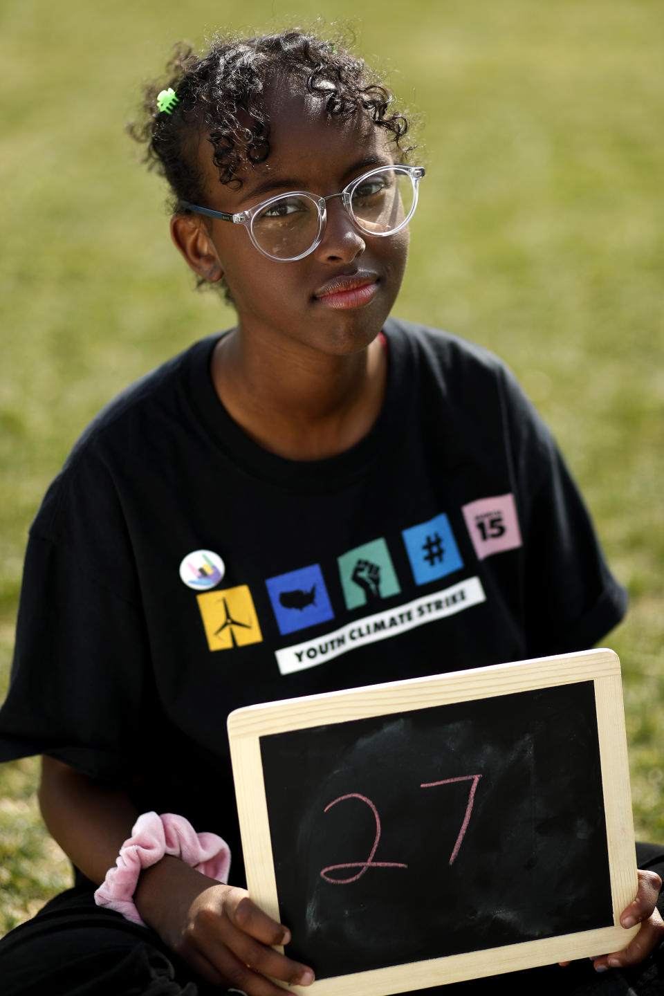 Isra Hirsi, 16, of Minneapolis, the daughter of Sen. Ilhan Omar, D-Minn., poses for a portrait with a chalkboard stating her age in 2030, the point where the globe would be stuck on a path toward what scientists call planet-changing dangerous warming, Friday, March 15, 2019, during a climate change rally of students in Washington that was co-led by Hirsi. "It's important to advocate for those who can't control how climate change affects them," says Hirsi, "and there are lots of youth who are not aware of what's going on with our climate." From the South Pacific to the edge of the Arctic Circle, students are skipping classes to protest what they see as the failures of their governments to take tough action against global warming. The 'school strikes' on Friday were inspired by 16-year-old Swedish activist Greta Thunberg and are taking place in over 100 countries. (AP Photo/Jacquelyn Martin)