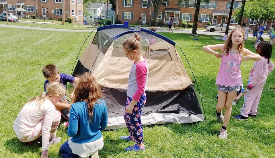 "Campers" erect a tent during Washington County Day Camp.