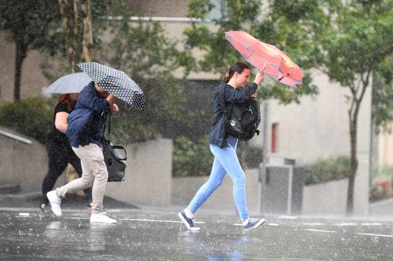 People walk in rainy weather in central Brisbane.