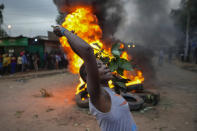 Shouting "No Raila No Peace," Kenyan opposition leader Raila Odinga supporters burn tIres in the Kibera neighborhood of Nairobi, Kenya, Monday, Aug. 15, 2022. Kenya’s electoral commission chairman has declared Deputy President William Ruto the winner of the close presidential election over five-time contender Raila Odinga, a triumph for the man who shook up politics by appealing to struggling Kenyans on economic terms and not on traditional ethnic ones. (AP Photo/Ben Curtis)