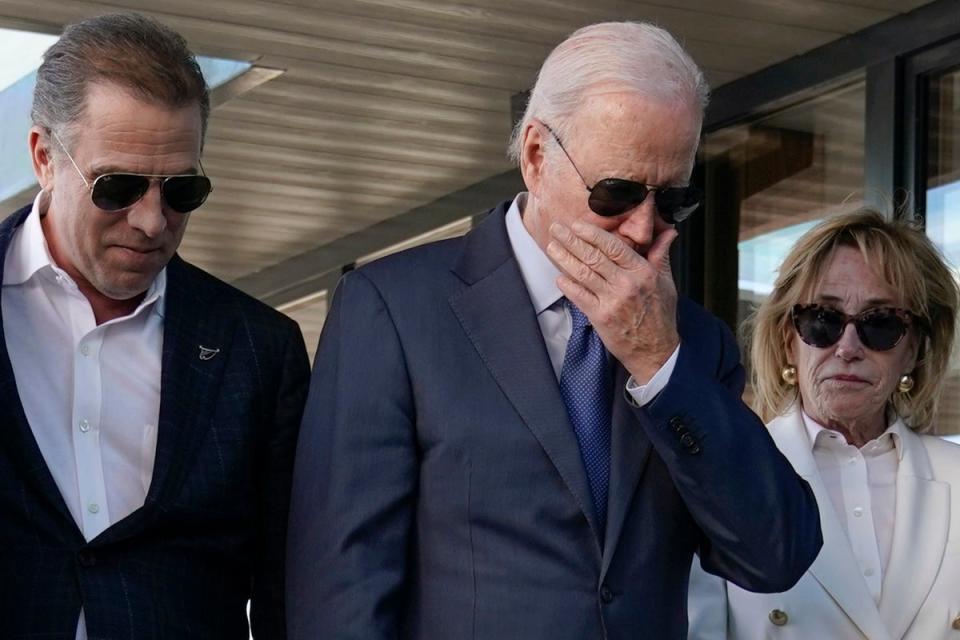 President Joe Biden stands with his son Hunter Biden, left, and sister Valerie Biden Owens, second from right, as he looks at a plaque dedicated to his late son Beau Biden while visiting Mayo Roscommon Hospice in County Mayo (AP)