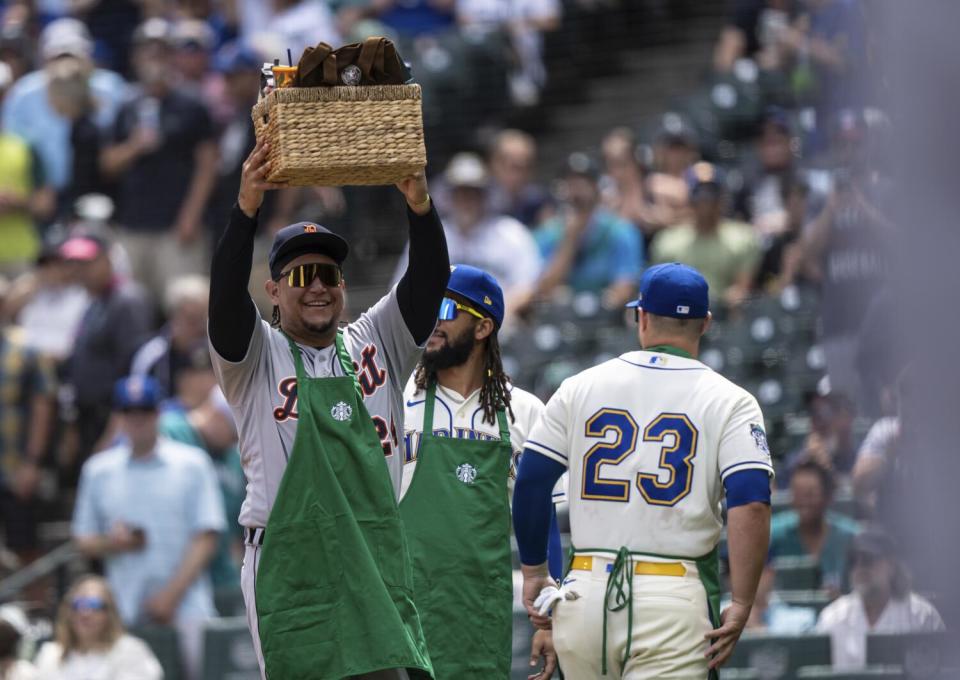 Miguel Cabrera holds up a Starbucks gift basket given to him by the Seattle Mariners