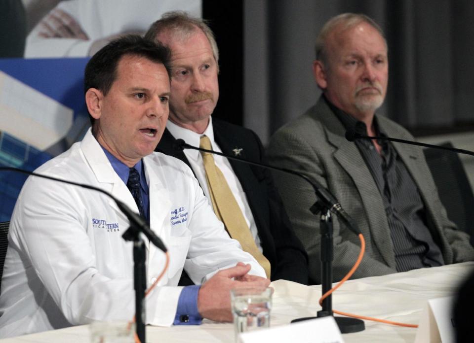 Dallas Stars medical services director Dr. Robert J. Dimeff, M.D., left, answers questions regarding forward Rich Peverley and the incident which occurred in a recent NHL game during a news conference at UT Southwestern Medical Center Wednesday, March 12, 2014, in Dallas, while Stars' general manager Bill Nill and coach Lindy Ruff, right, listen. (AP Photo/Tim Sharp)