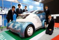 Students from Aichi Highschool of Technology and Engineering pose next to their developed electric vehicle named Collapse during media preview of the 45th Tokyo Motor Show in Tokyo, Japan October 25, 2017. REUTERS/Toru Hanai