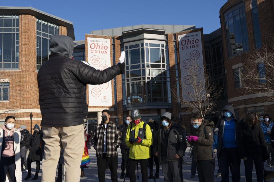 Mark Stansberry, left, a member of Communication Workers of America Local 4502, speaks Friday at a protest outside the Ohio Student Union by Ohio State student workers who want the university to raise their minimum wage to $15 an hour. "Back in 2000, CWA did a strike on campus to raise the minimum wage for organized workers on campus to $10 an hour," Stansberry said.