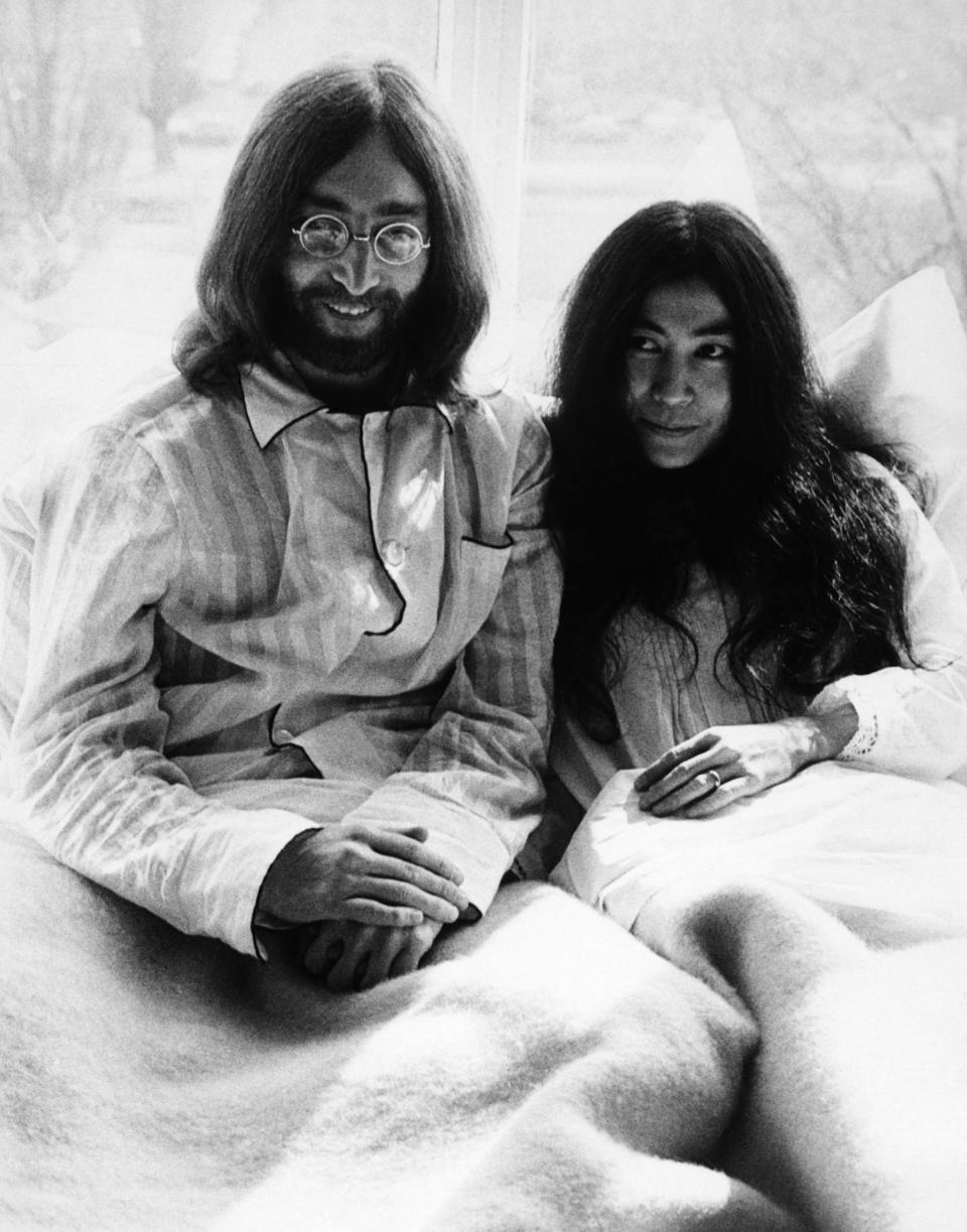 <p>John Lennon and Yoko Ono in bed during their honeymoon at the Amsterdam Hilton Hotel. They told the press that they would stay in bed for seven days to protest violence.</p>