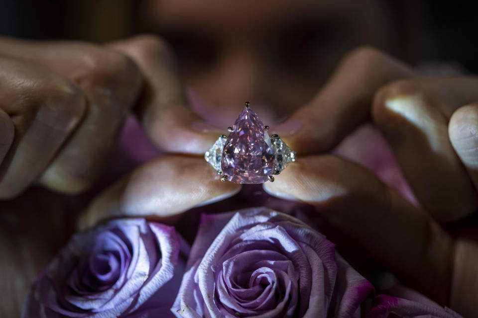 A Christie's employee displays a pink diamond called 