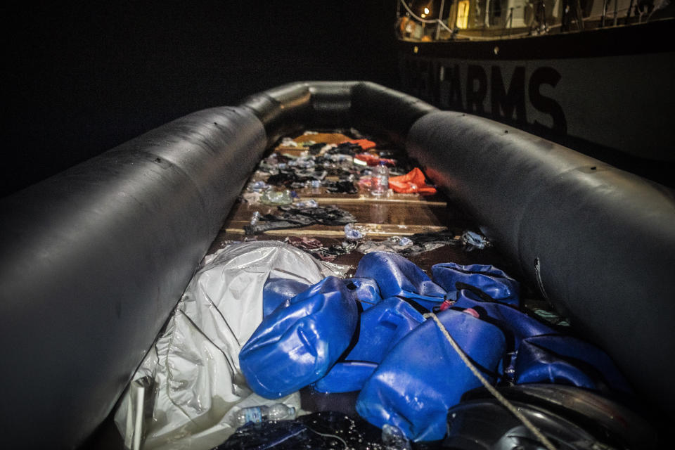 The dead body of a man is covered under white plastic inside a rubber boat during a rescue operation performed by Spanish NGO Open Arms and the Louise Michel rescue vessel 70 miles southwest Malta, in the Central Mediterranean sea, Saturday, Aug. 29, 2020. A rescue ship painted and sponsored by British artist Banksy saved another 130 migrants stranded on a rubber boat in the Southern Mediterranean Sea. (AP Photo/Santi Palacios)