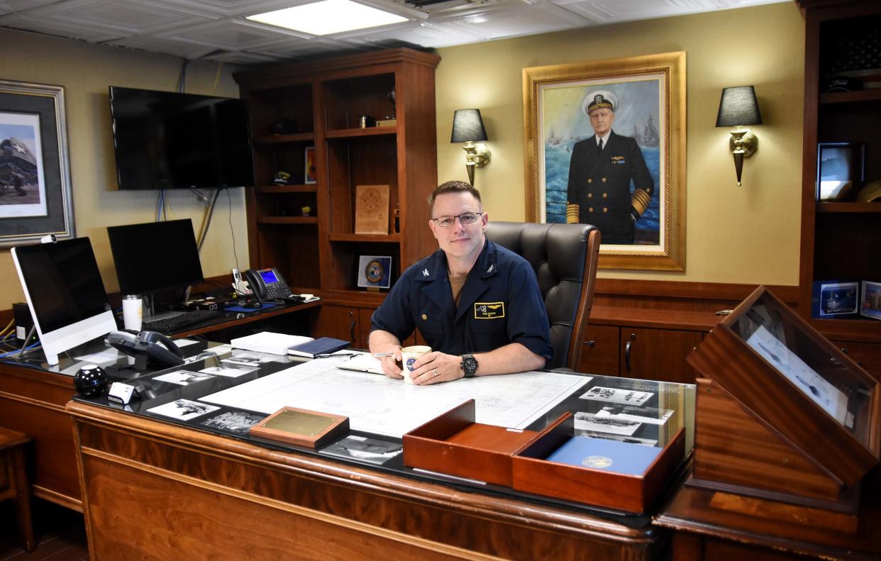 Capt. Douglas Graber sits at his office on the USS Nimitz aircraft carrier on July 1, 2023. Graber relieves Capt. Craig Sicola as commanding officer of the Nimitz on June 29, 2023.