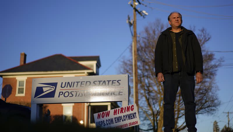 Gerald Groff, a former postal worker whose case was decided by the Supreme Court, stands during a television interview near a “Now Hiring” sign posted on the roadside at the United State Postal Service, March 8, 2023, in Quarryville, Pa. The Supreme Court on Thursday, June 29, used the case of a Christian mailman who didn’t want to work Sundays to solidify protections for workers who are religious. 