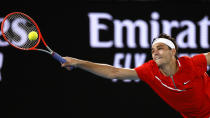 Taylor Fritz of the U.S. makes a forehand return to Stefanos Tsitsipas of Greece during their fourth round match at the Australian Open tennis championships in Melbourne, Australia, Monday, Jan. 24, 2022. (AP Photo/Tertius Pickard)