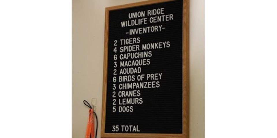 A signboard listing 35 animals at Union Ridge Wildlife Center, Vinton Township, Ohio, including "4 spider monkeys" and "2 tigers."