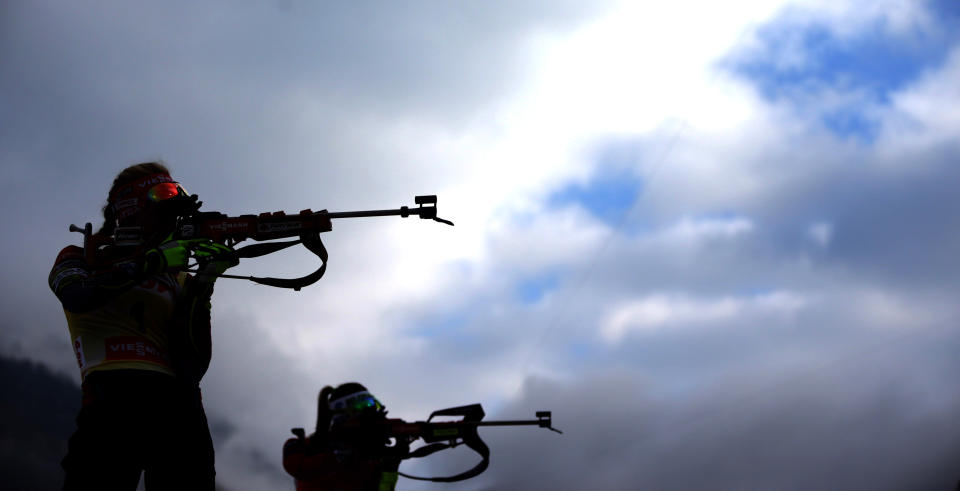 Gabriela Soukalova of Czech Republic, foreground left, and Darya Domracheva of Belarus shoot during the women's Pursuit 10 km competition at the Biathlon World Cup in Ruhpolding, Germany, Sunday, Jan, 12, 2014. (AP Photo/Matthias Schrader)