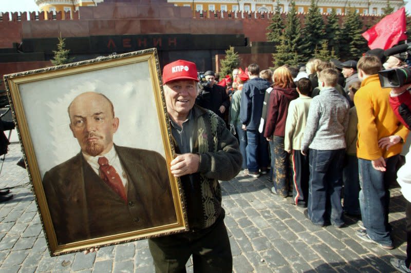 A Russian communist activist holds a portrait of Soviet founder Vladimir Lenin in Moscow on April 22, 2006. On January 21, 1924, Lenin, architect of the Bolshevik Revolution and the first leader of the Soviet Union, died of a brain hemorrhage at the age of 54. File Photo by Anatoli Zhdanov/UPI