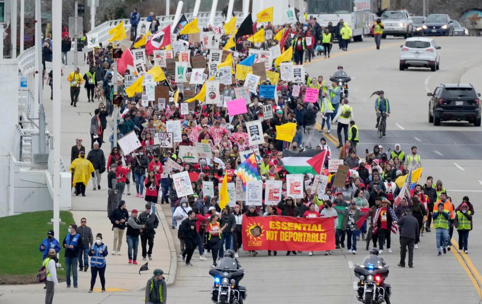 People head down South 6th Street during a march for immigration reform in Milwaukee on Sunday, May 1, 2022. The event included immigrant essential workers and families, as well as allies in the faith, labor, LGBTQ, reproductive justice, and social justice communities supporting immigration reform.