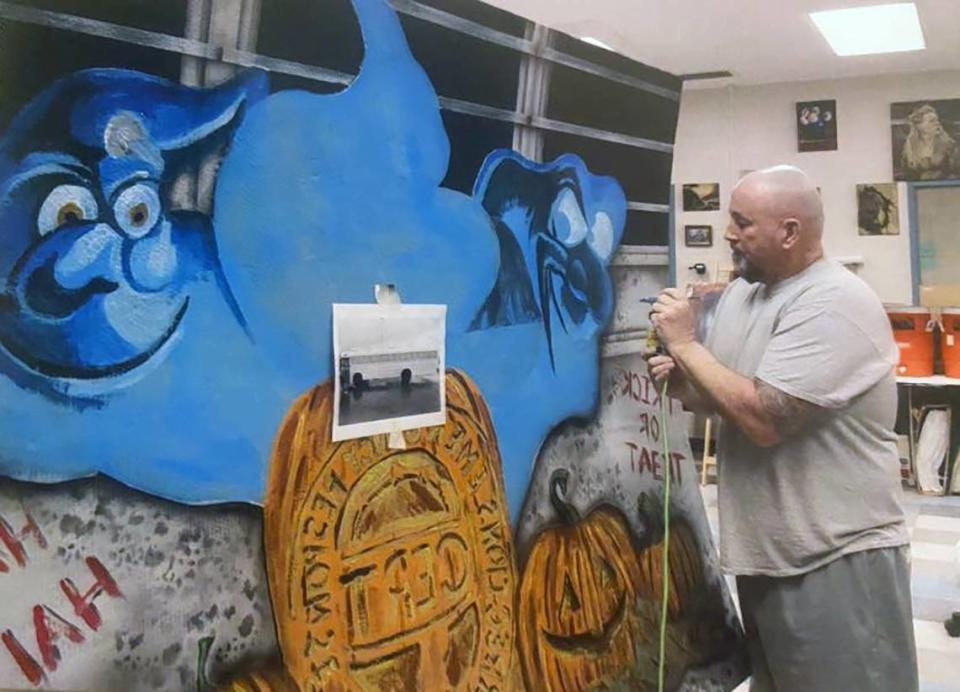 Prisoner Ed “Butch” Reuscher paints