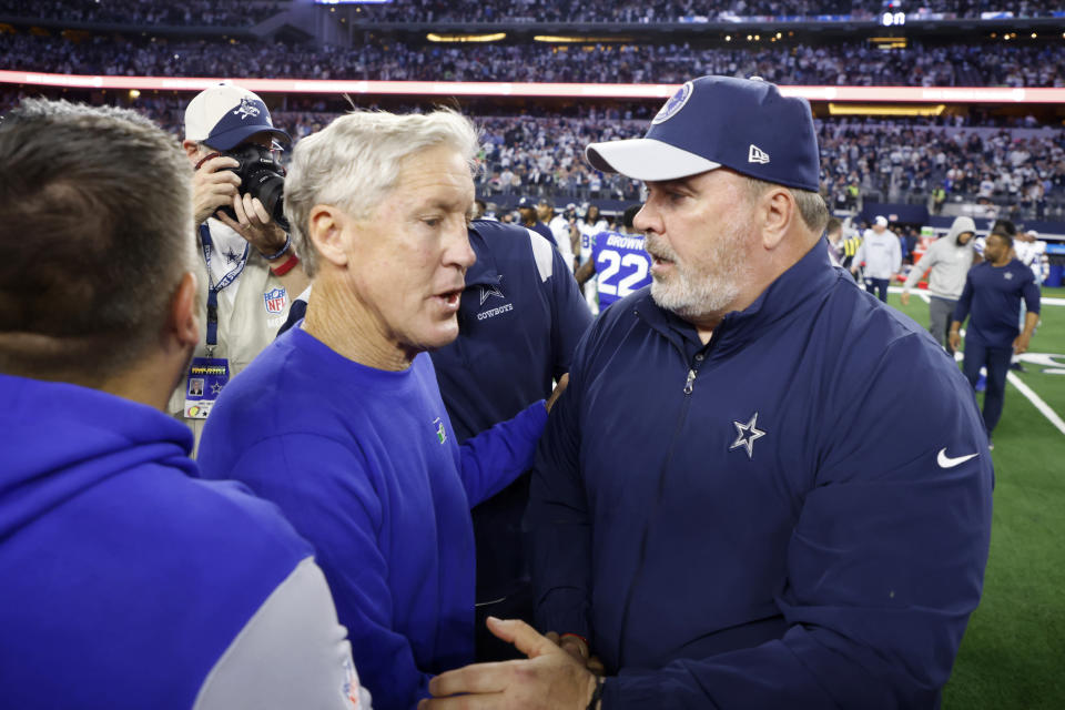 Seattle Seahawks head coach Pete Carroll, left, and Dallas Cowboys head coach Mike McCarthy, right, greet each other on the field after their team's NFL football game in Arlington, Texas, Thursday, Nov. 30, 2023. (AP Photo/Michael Ainsworth)