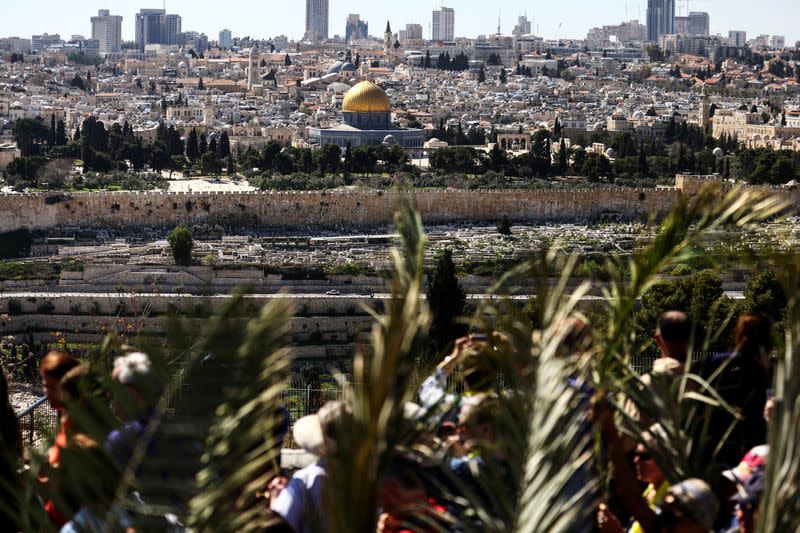 Christian worshippers attend a Palm Sunday procession on the Mount of Olives in Jerusalem