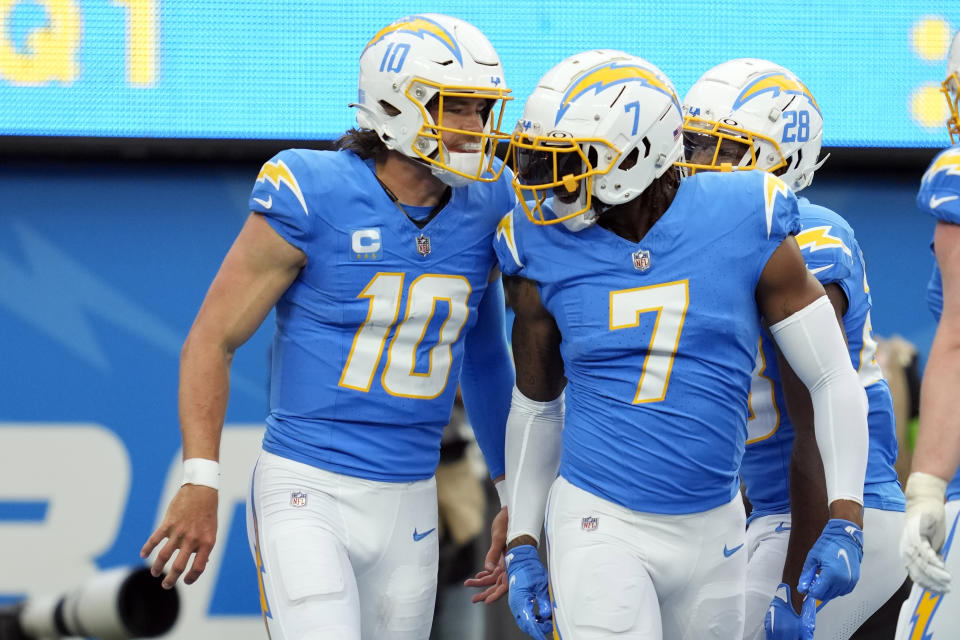 Los Angeles Chargers quarterback Justin Herbert (10) celebrates his touchdown run with tight end Gerald Everett (7) during the first half of an NFL football game against the Las Vegas Raiders Sunday, Oct. 1, 2023, in Inglewood, Calif. (AP Photo/Ashley Landis)