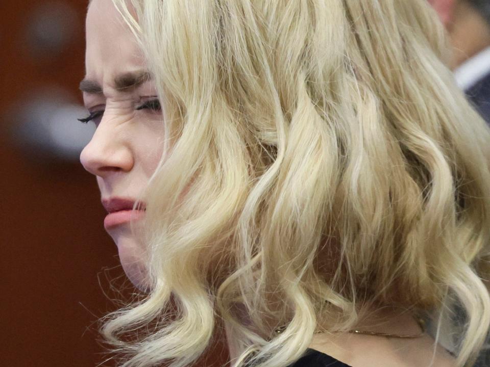 Amber Heard looks at attorney before verdict is read