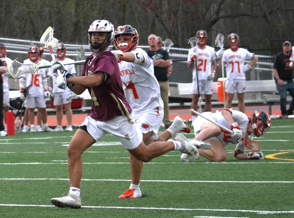 Iona Prep midfielder Christian Tapia rushed upfield with a face-off win during the Gaels 11-10 overtime loss to Ridgefield, Conn. on April 29, 2024 at Ridgefield High School.