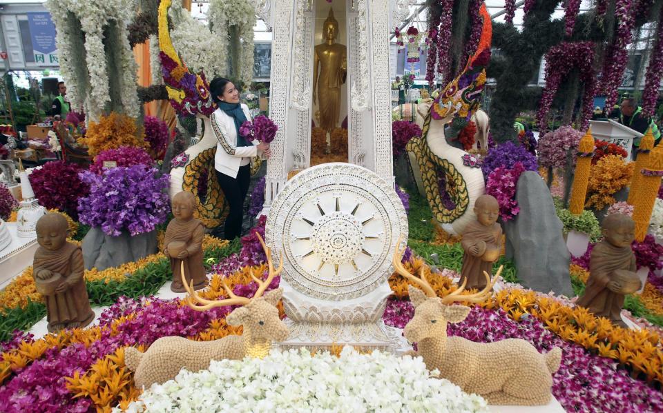 An ornate Thailand Garden is tended to by Ploy Pan Patrathiranond during last-minute preparations for the Chelsea Flower Show (PA)