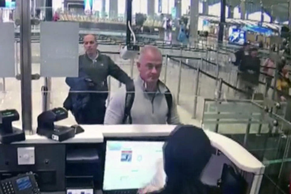 FILE—This Dec. 30, 2019 image from security camera video shows Michael L. Taylor, center, and George-Antoine Zayek at passport control at Istanbul Airport in Turkey. Taylor is accused of smuggling former Nissan Motor Co. Chairman Carlos Ghosn out of Japan in 2019 while he was awaiting trial on financial misconduct charges. (DHA via AP, File)