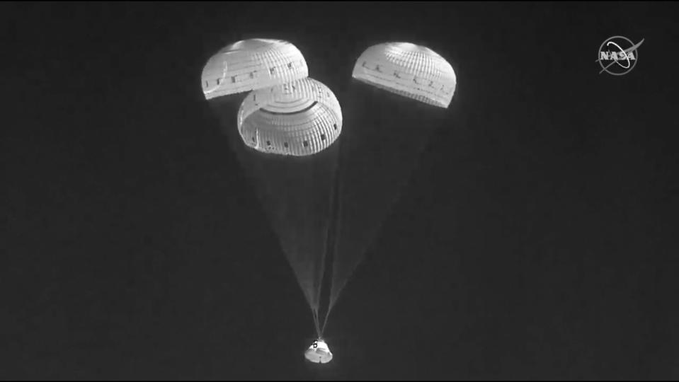 In this infrared image from video made available by NASA, the Boeing Starliner capsule uses parachutes as it descends to land at the White Sands Missile Range in New Mexico on Wednesday, May 25, 2022. (NASA via AP)