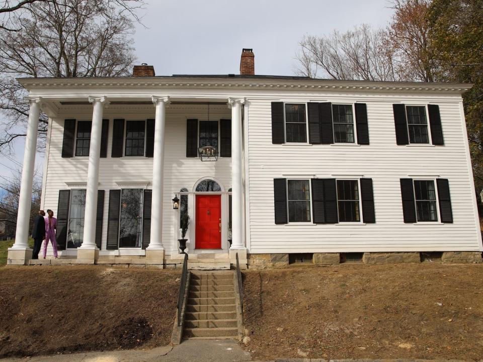 Robert Hartwell in front of his white plantation style house in "breaking new ground"