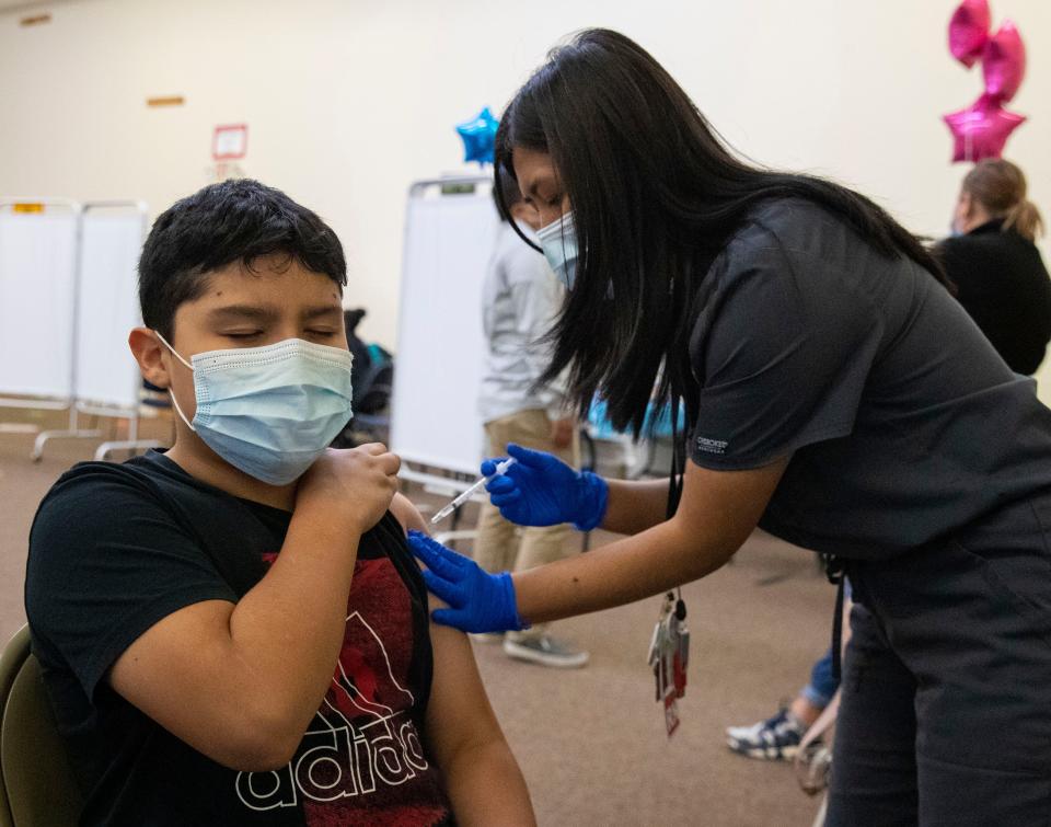 Osman Bardales, 11, is vaccinated by Ngun Hnem on Monday, Nov. 15, 2021, in Indianapolis at a Marion County Local Health Department COVID-19 vaccine location. Vaccines at the location were only administered to kids, with a focus on those aged 5 to 11. 