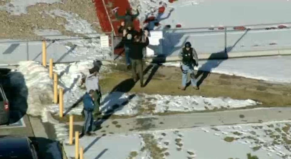 Students from Arapahoe High School evacuate their building in Centennial, Colorado December 13, 2013 in this still image from video Courtesy KUSA, Channel 9 during a shooting incident in which at least two students were injured. Police reported the gunman took his own life. REUTERS/Courtesy KUSA, Channel 9 (UNITED STATES - Tags: CRIME LAW) NO SALES. NO ARCHIVES. FOR EDITORIAL USE ONLY. NOT FOR SALE FOR MARKETING OR ADVERTISING CAMPAIGNS. THIS IMAGE HAS BEEN SUPPLIED BY A THIRD PARTY. IT IS DISTRIBUTED, EXACTLY AS RECEIVED BY REUTERS, AS A SERVICE TO CLIENTS
