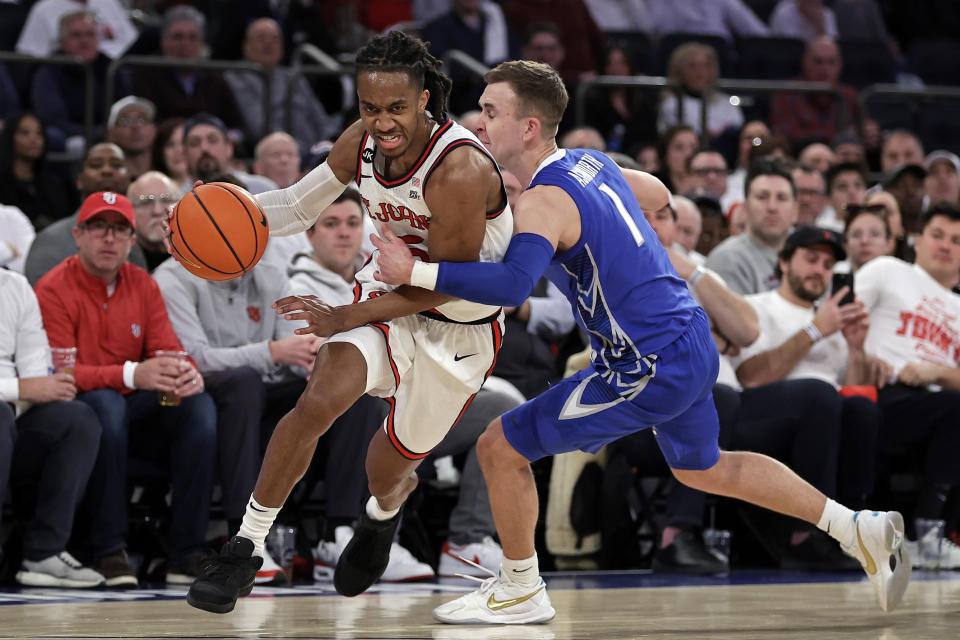 St. John's guard Daniss Jenkins drives past Creighton guard Steven Ashworth (1) during the second half of an NCAA college basketball game, Sunday, Feb. 25, 2024, in New York. (AP Photo/Adam Hunger)