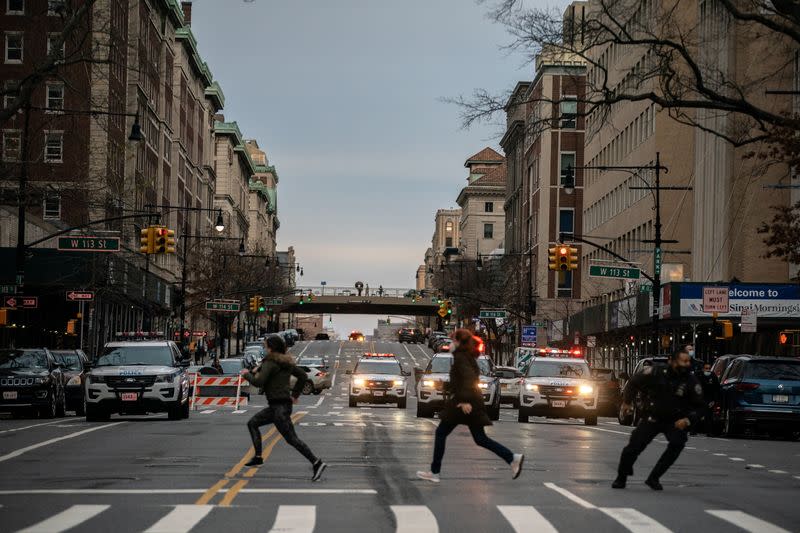 People run after a man opened fire outside the Cathedral Church of St. John the Divine in Manhattan