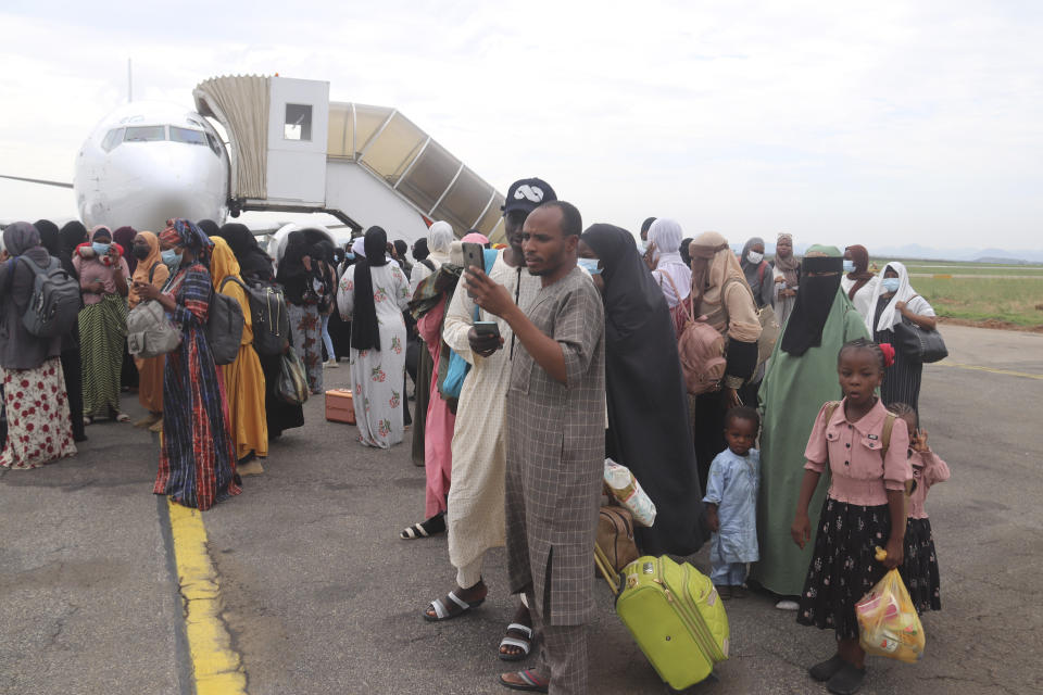 Nigerians who were evacuated from Sudan arrive at the Nnamdi Azikiwe International Airport in Abuja, Nigeria, Friday, May 5, 2023. Many Africans escaping the conflict in Sudan that erupted with little warning last month faced a long wait - three weeks for some - to get out and severe challenges on the way as their governments stuggled to mobilize resources. (AP Photo/Gbemiga Olamikan)