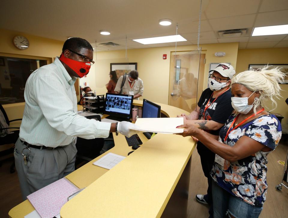 In DeLand, Michael Forrester, at left, works to help residents at The Bridge, a crisis shelter and day center for homeless people, on Sept. 28, 2020. Forrester was terminated from his role as the shelter's executive director on Dec. 14, 2021.