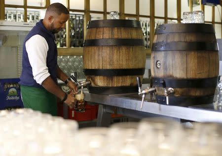 A waiter fills up beer mugs in a restaurant at 'Kloster Andechs' in Andechs near Munich, Germany, April 19, 2016. REUTERS/Michaela Rehle