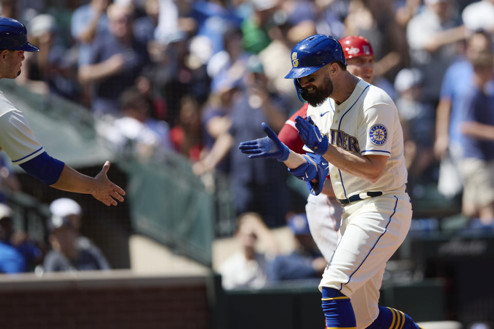 Seattle Mariners' Jesse Winker celebrates as he heads home after hitting a grand slam against the Los Angeles Angels on a pitch from Tucker Davidson during third inning of a baseball game, Sunday, Aug. 7, 2022, in Seattle. (AP Photo/John Froschauer)