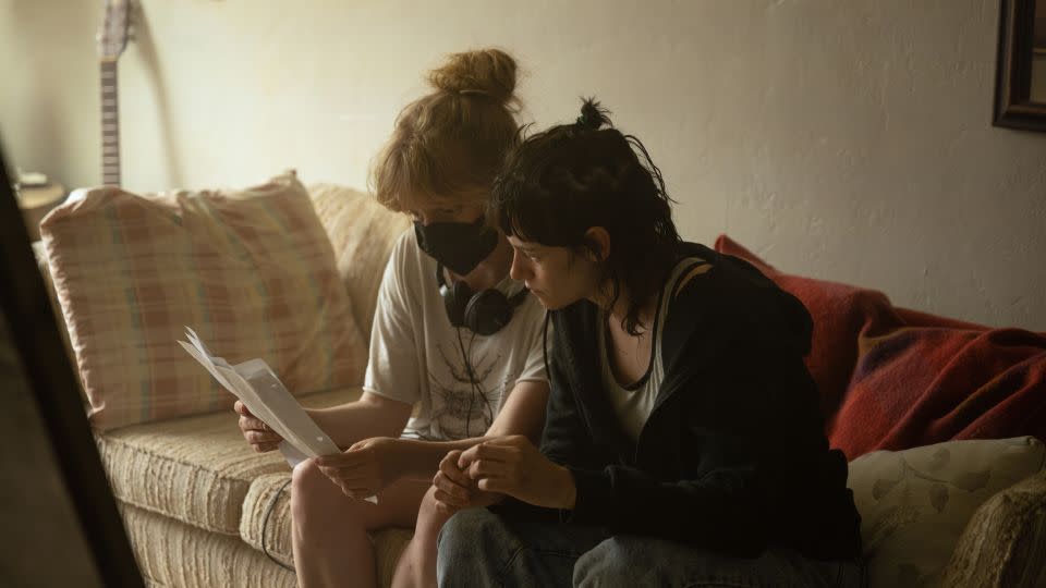 Writer-director Rose Glass and actor Kristen Stewart in discussion on the set of "Love Lies Bleeding." - Anna Kooris/A24