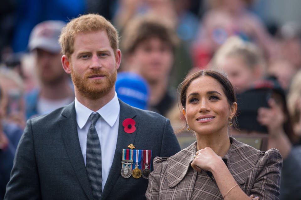 Harry and Meghan standing together