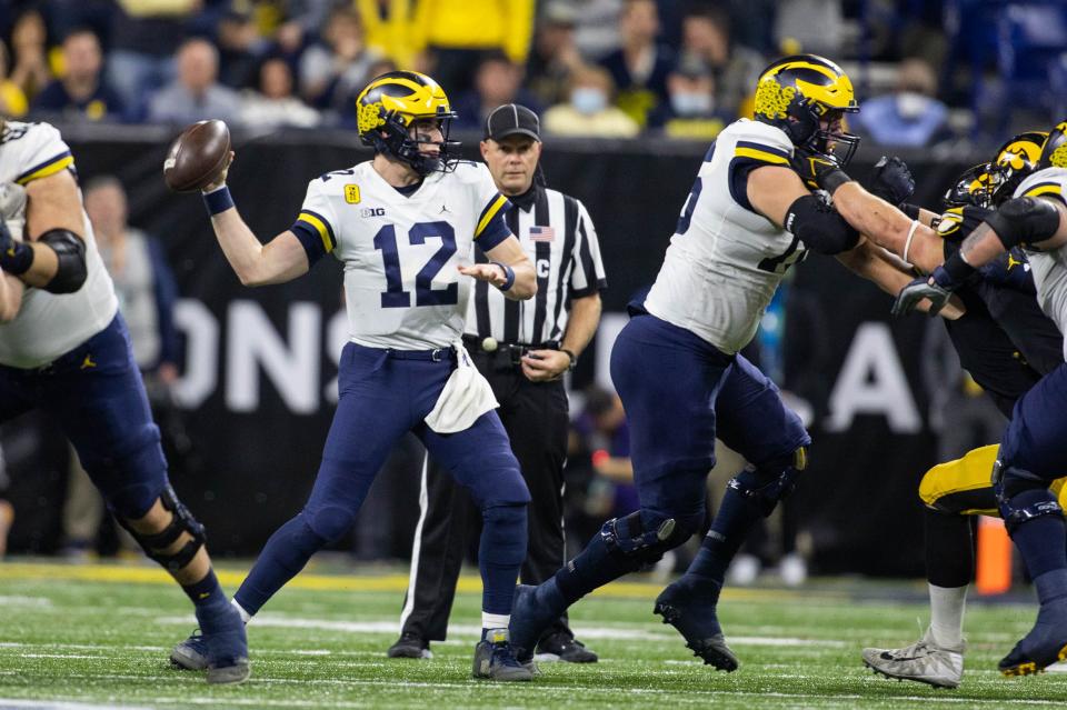 Michigan quarterback Cade McNamara (12) passes the ball in the second quarter against Iowa during the 2021 Big Ten championship game at Lucas Oil Stadium.