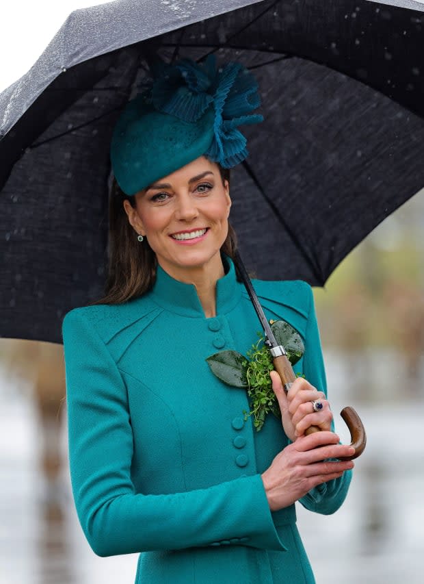 Britain's Catherine, Princess of Wales shelters from the rain beneath an umbrella during a visit to the 1st Battalion Irish Guards for their St Patrick's Day Parade, at Mons Barracks in Aldershot, southwest of London, on March 17, 2023.<p><a href="https://www.gettyimages.com/detail/1248446275" rel="nofollow noopener" target="_blank" data-ylk="slk:CHRIS JACKSON/Getty Images;elm:context_link;itc:0;sec:content-canvas" class="link ">CHRIS JACKSON/Getty Images</a></p>