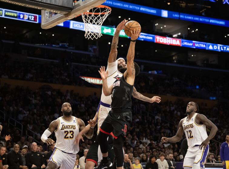 LOS ANGELES, CA - DECEMBER 2, 2023: Los Angeles Lakers forward Anthony Davis (3) blocks a hot by Houston Rockets guard Fred VanVleet (5) in the first half at Crypton.com Arena on December 2, 2023 in Los Angeles, California.(Gina Ferazzi / Los Angeles Times)