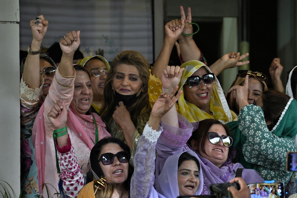 Supporters of imprisoned former Prime Minister Imran Khan's party Tehreek-e-Insaf, react after a Supreme Court decision in a case of reserved seats for women and minorities in the parliament, in Islamabad, Pakistan, Friday, July 12, 2024. Pakistan's top court on Friday ruled that the party of imprisoned former Prime Minister Khan is eligible for seats reserved in the parliament, a major blow to the country's weak coalition government. (AP Photo/Anjum Naveed)